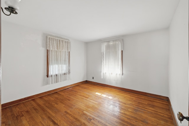 24 Goff St, Waterbury, CT 06704 - spare room with healthy amount of natural light, wood finished floors, and baseboards