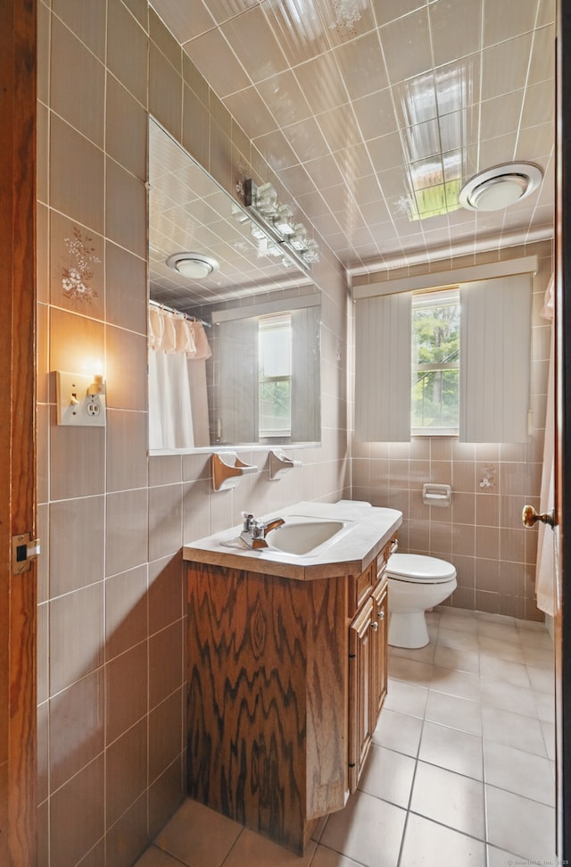 24 Goff St, Waterbury, CT 06704 - full bath featuring tile walls, vanity, tile patterned floors, toilet, and a shower with shower curtain