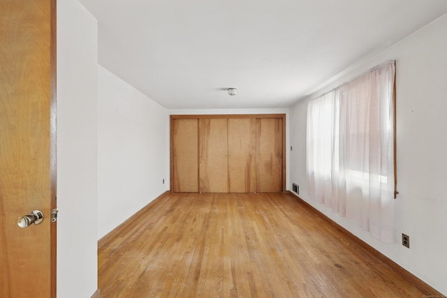 24 Goff St, Waterbury, CT 06704 - unfurnished bedroom with light wood-style flooring and a closet