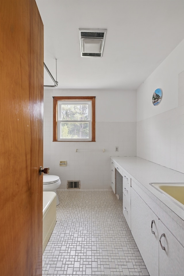 24 Goff St, Waterbury, CT 06704 - full bathroom featuring a bath, vanity, toilet, and tile walls