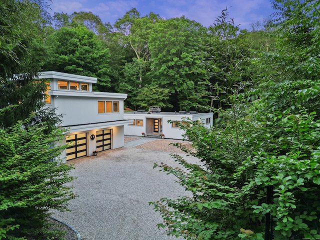 99 High Ridge Rd, Pound Ridge, NY 10576 - contemporary home featuring gravel driveway and an attached garage