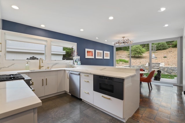 99 High Ridge Rd, Pound Ridge, NY 10576 - kitchen featuring dishwasher, a sink, a peninsula, recessed lighting, and a chandelier