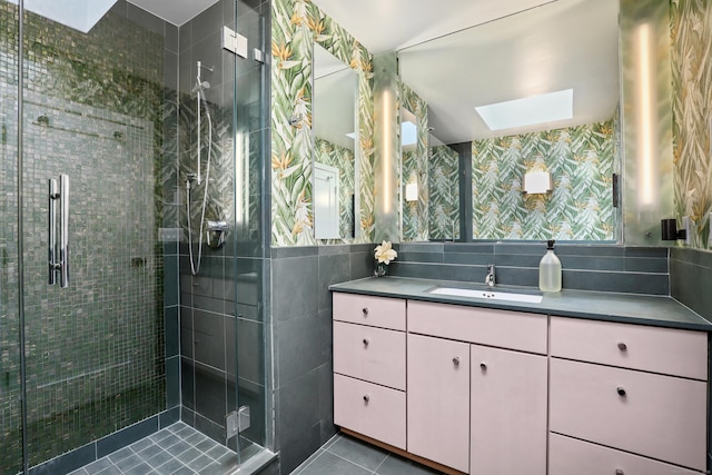 99 High Ridge Rd, Pound Ridge, NY 10576 - bathroom featuring a skylight, vanity, tile walls, a stall shower, and tile patterned flooring