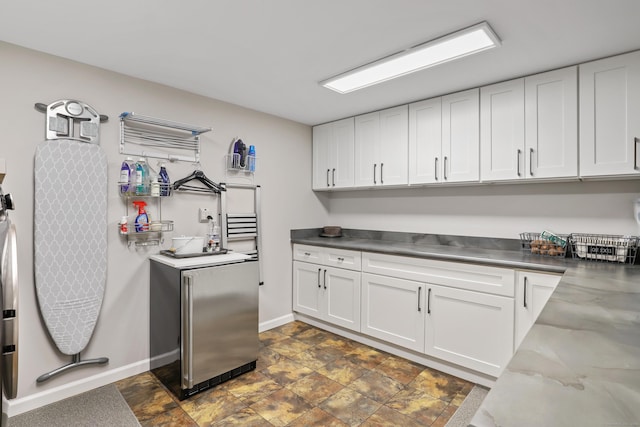 99 High Ridge Rd, Pound Ridge, NY 10576 - kitchen featuring stainless steel counters, white cabinets, stainless steel refrigerator, baseboards, and stone finish flooring