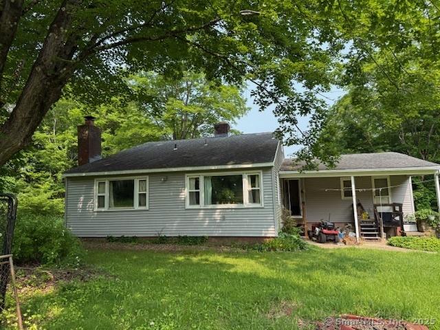 789 Tuttle Ave, Hamden, CT 06518 - back of property with a chimney, a yard, and a porch