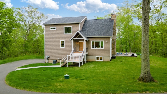 732 Hulls Hill Rd, Southbury, CT 06488 - view of front facade featuring a front lawn, central AC, a shingled roof, and a chimney