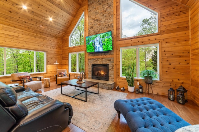 732 Hulls Hill Rd, Southbury, CT 06488 - living area featuring high vaulted ceiling, wooden walls, wooden ceiling, a fireplace, and hardwood / wood-style flooring