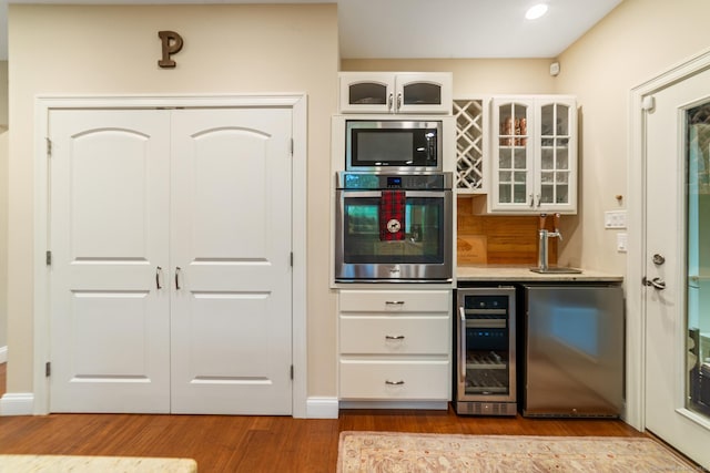 732 Hulls Hill Rd, Southbury, CT 06488 - bar area featuring appliances with stainless steel finishes, wine cooler, and wood finished floors
