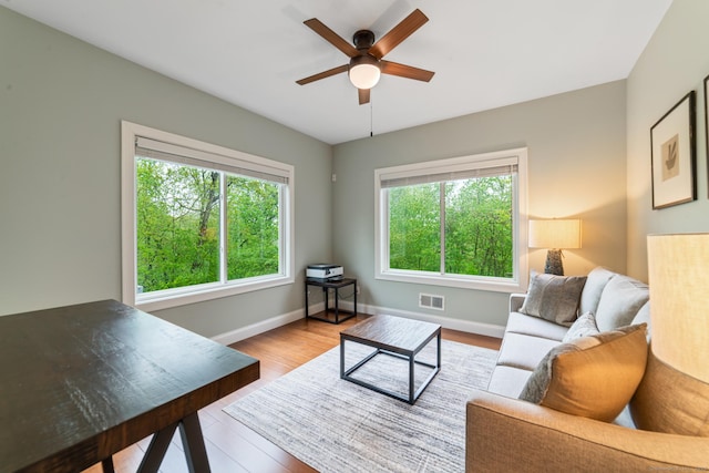732 Hulls Hill Rd, Southbury, CT 06488 - living area with healthy amount of natural light, ceiling fan, wood finished floors, and baseboards