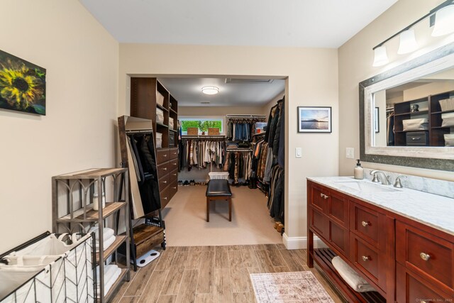 732 Hulls Hill Rd, Southbury, CT 06488 - full bath with vanity, wood finish floors, a walk in closet, and baseboards