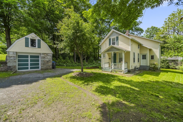 245 Riverside Ave, Torrington, CT 06790 - view of front of home with an outdoor structure, driveway, a front yard, a detached garage, and covered porch