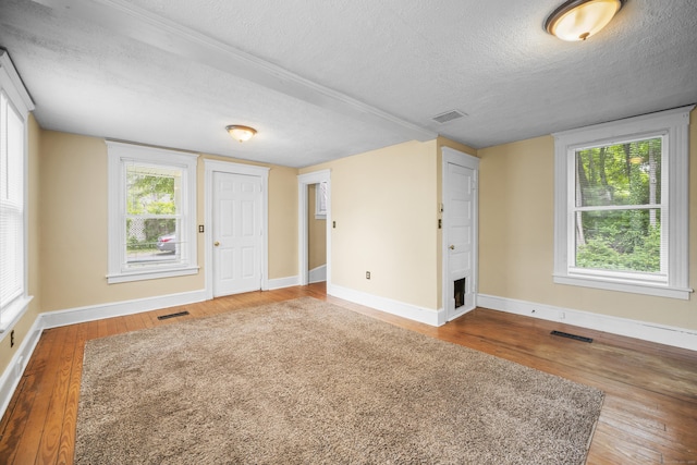 245 Riverside Ave, Torrington, CT 06790 - empty room featuring a textured ceiling, wood finished floors, and baseboards