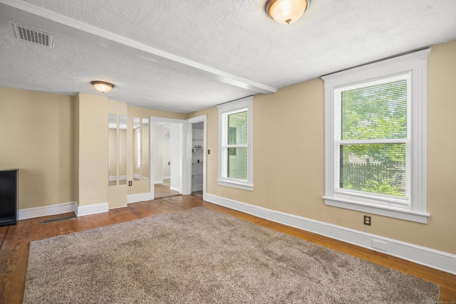245 Riverside Ave, Torrington, CT 06790 - unfurnished living room featuring a textured ceiling, wood finished floors, baseboards, and plenty of natural light