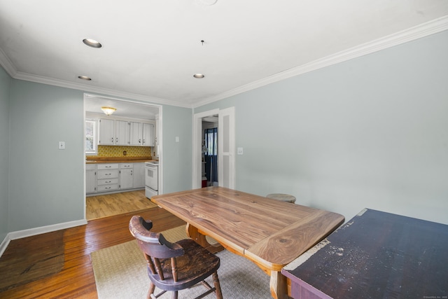 245 Riverside Ave, Torrington, CT 06790 - dining room featuring light wood finished floors, ornamental molding, recessed lighting, baseboards, and bar area