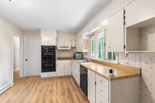 33 Deer Park Rd, Simsbury, CT 06089 - kitchen featuring wallpapered walls, black appliances, a sink, under cabinet range hood, and light wood-style flooring