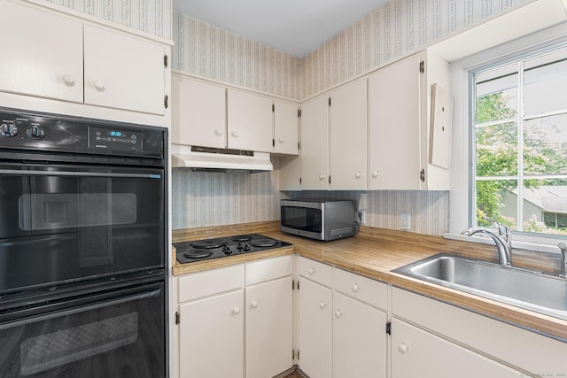 33 Deer Park Rd, Simsbury, CT 06089 - kitchen featuring wallpapered walls, black appliances, under cabinet range hood, a sink, and light countertops