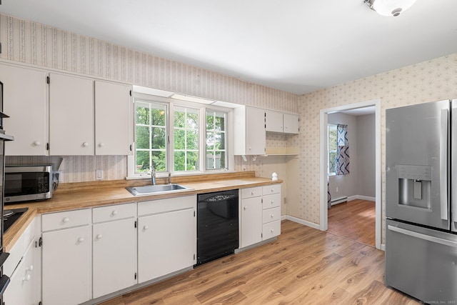 33 Deer Park Rd, Simsbury, CT 06089 - kitchen featuring black appliances, wallpapered walls, a sink, light wood finished floors, and healthy amount of natural light