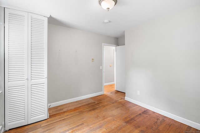 33 Deer Park Rd, Simsbury, CT 06089 - unfurnished bedroom with a closet, baseboards, and wood finished floors