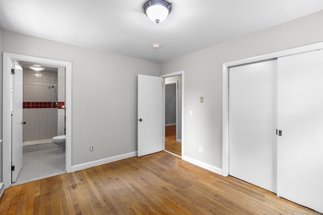 33 Deer Park Rd, Simsbury, CT 06089 - unfurnished bedroom with wood finished floors, a closet, baseboards, and connected bathroom