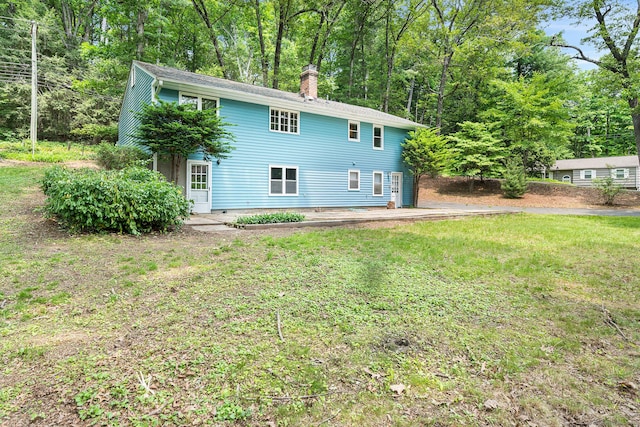 33 Deer Park Rd, Simsbury, CT 06089 - back of property with a chimney and a yard