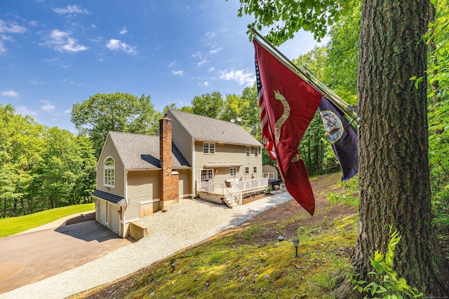 1382 Cedar Swamp Rd, Coventry, CT 06238 - view of front of home featuring driveway, a chimney, a wooden deck, and a garage