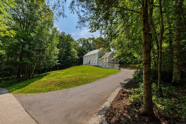 1382 Cedar Swamp Rd, Coventry, CT 06238 - view of front of house with an attached garage, asphalt driveway, and a front yard
