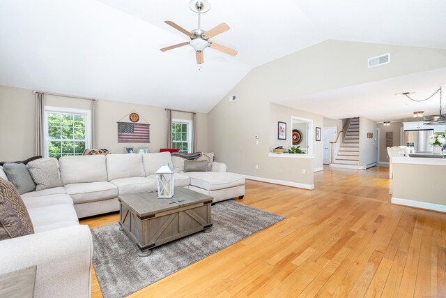 1382 Cedar Swamp Rd, Coventry, CT 06238 - living room featuring vaulted ceiling, stairway, a ceiling fan, light wood-style floors, and plenty of natural light