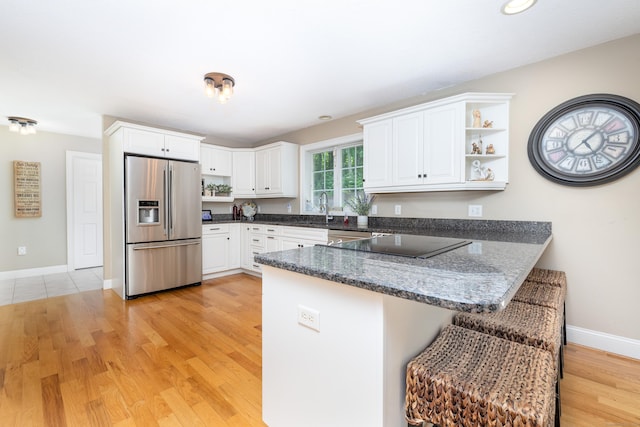 1382 Cedar Swamp Rd, Coventry, CT 06238 - kitchen featuring stainless steel refrigerator with ice dispenser, a peninsula, open shelves, a sink, and light wood-type flooring