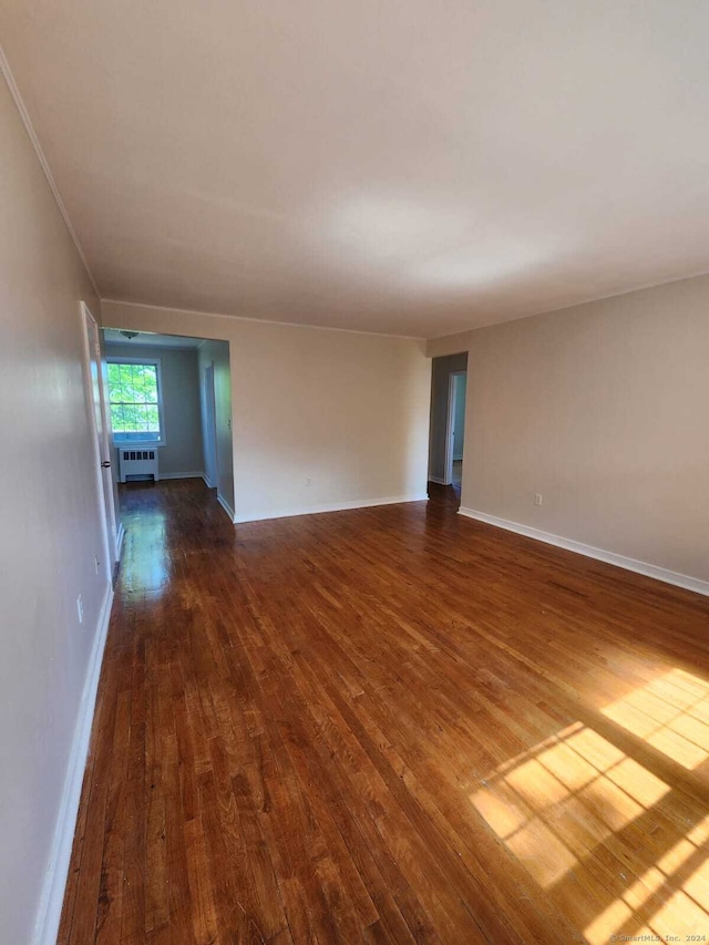 275 Texas Ave Unit D, Bridgeport, CT 06610 - spare room featuring dark wood-style flooring, radiator heating unit, and baseboards