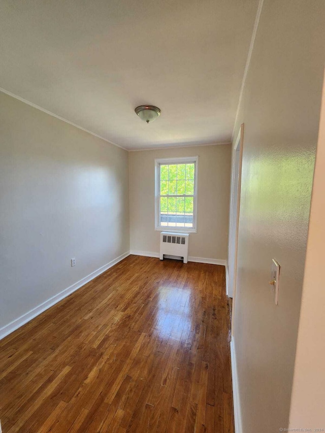 275 Texas Ave Unit D, Bridgeport, CT 06610 - spare room with radiator heating unit, dark wood finished floors, crown molding, and baseboards