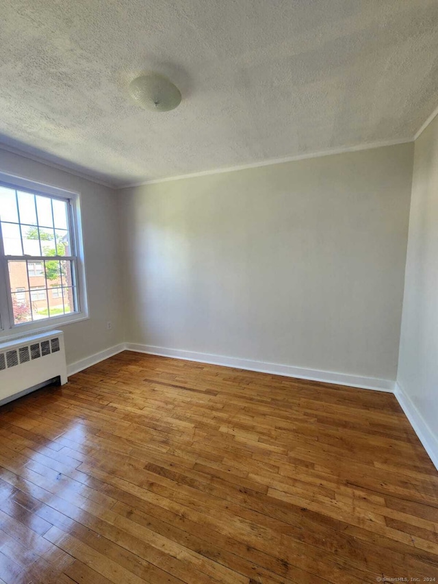 275 Texas Ave Unit D, Bridgeport, CT 06610 - spare room with hardwood / wood-style floors, radiator, crown molding, a textured ceiling, and baseboards