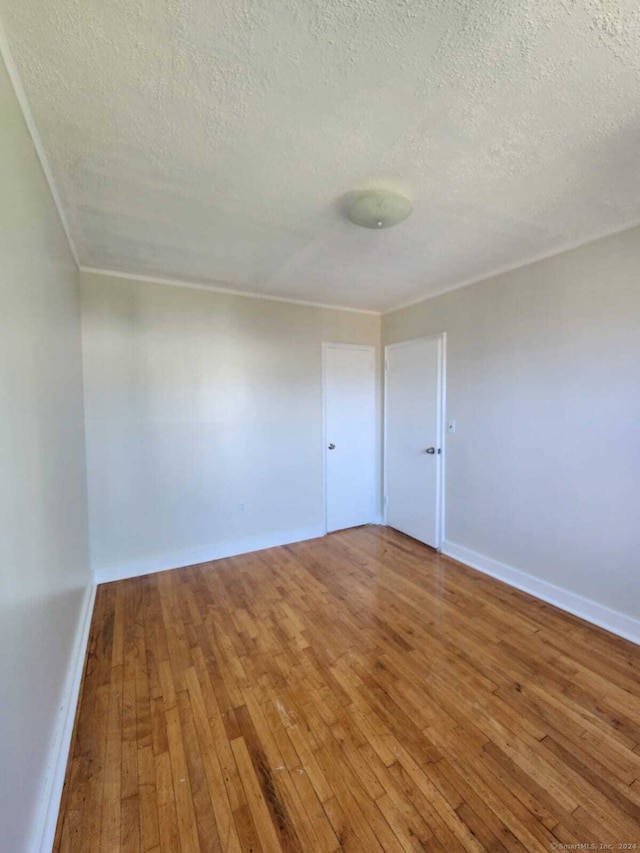 275 Texas Ave Unit D, Bridgeport, CT 06610 - spare room with a textured ceiling, light wood finished floors, and baseboards