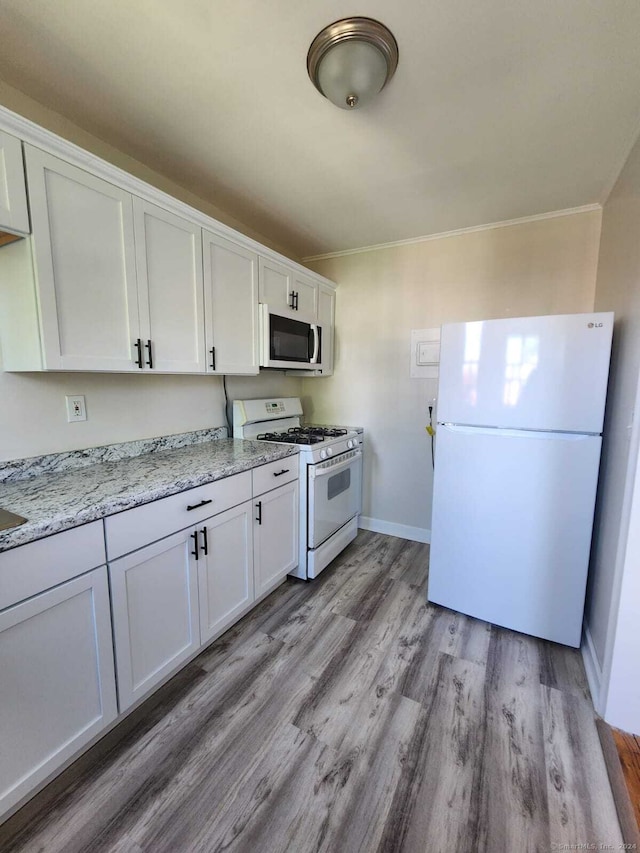 275 Texas Ave Unit D, Bridgeport, CT 06610 - kitchen with white appliances, ornamental molding, light wood finished floors, white cabinetry, and baseboards