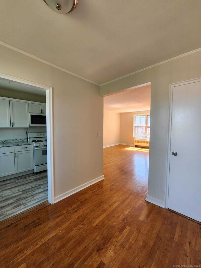 275 Texas Ave Unit D, Bridgeport, CT 06610 - unfurnished living room with ornamental molding, dark wood-type flooring, baseboards, and radiator