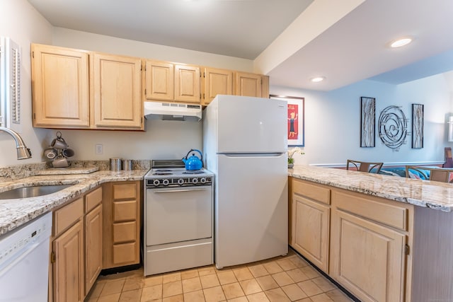 923 Old Pond Ln Unit 923, Norwich, CT 06360 - kitchen with white appliances, light brown cabinetry, a sink, under cabinet range hood, and a peninsula