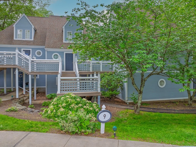 923 Old Pond Ln Unit 923, Norwich, CT 06360 - view of front facade featuring a deck, a shingled roof, and stairs