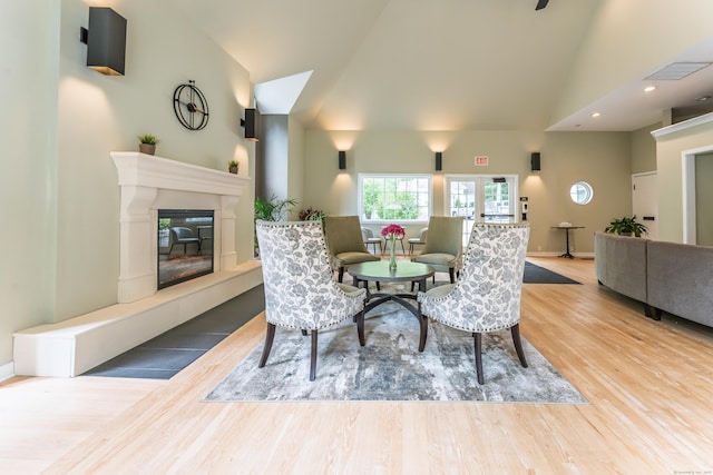 923 Old Pond Ln Unit 923, Norwich, CT 06360 - dining room with wood finished floors, a high end fireplace, high vaulted ceiling, recessed lighting, and baseboards