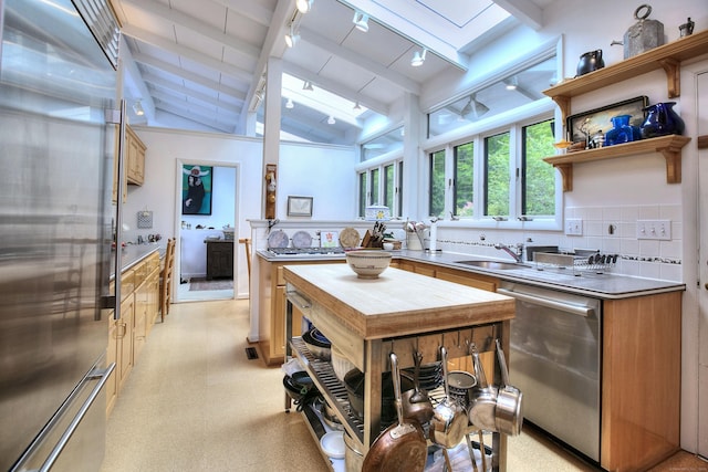 62 Wells Hill Rd, Weston, CT 06883 - kitchen featuring stainless steel appliances, a skylight, track lighting, and light countertops