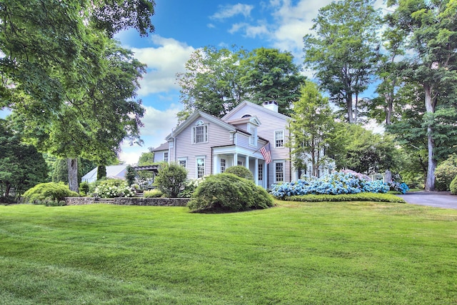 2683 Bronson Rd, Fairfield, CT 06824 - view of front of house featuring a front yard and a chimney
