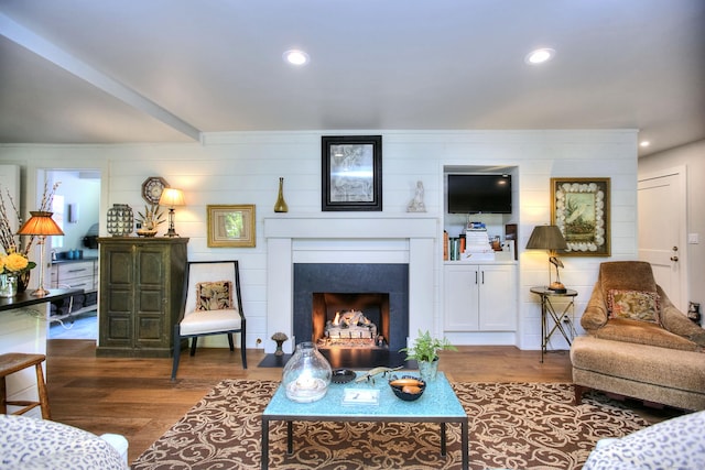2683 Bronson Rd, Fairfield, CT 06824 - living area with wood finished floors, a fireplace with flush hearth, and recessed lighting