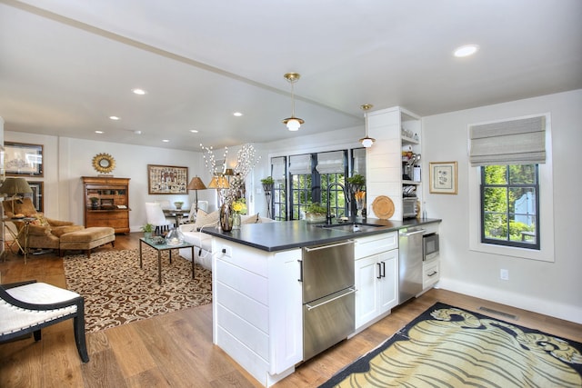 2683 Bronson Rd, Fairfield, CT 06824 - kitchen with appliances with stainless steel finishes, dark countertops, white cabinetry, healthy amount of natural light, and recessed lighting