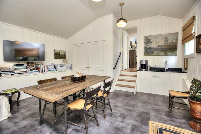 2683 Bronson Rd, Fairfield, CT 06824 - dining area featuring lofted ceiling, wooden walls, and stairs