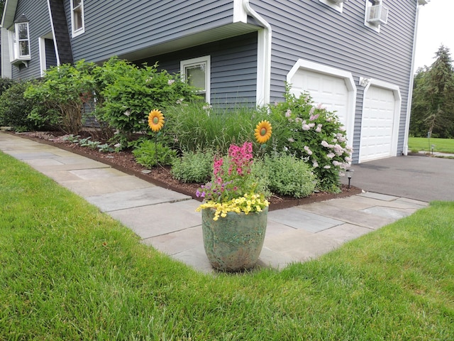 175 Cross Hill Rd, Monroe, CT 06468 - view of side of property with a garage, asphalt driveway, cooling unit, and a yard