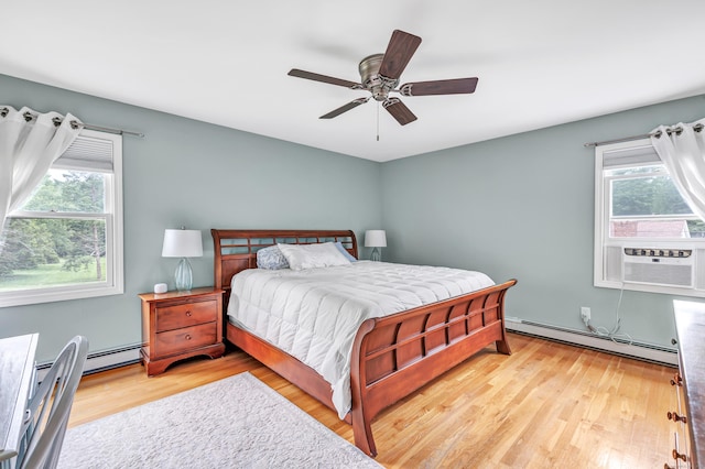 175 Cross Hill Rd, Monroe, CT 06468 - bedroom with a baseboard radiator, multiple windows, wood finished floors, and cooling unit