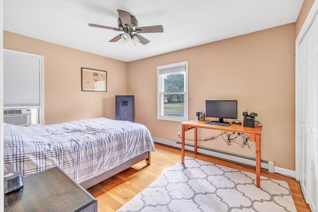 175 Cross Hill Rd, Monroe, CT 06468 - bedroom featuring baseboard heating, wood finished floors, cooling unit, baseboards, and a closet