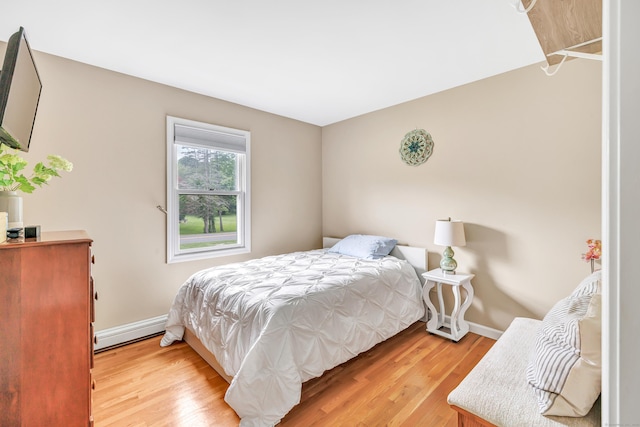 175 Cross Hill Rd, Monroe, CT 06468 - bedroom featuring baseboard heating, light wood-type flooring, and baseboards