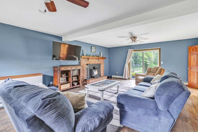 175 Cross Hill Rd, Monroe, CT 06468 - living area featuring ceiling fan, beam ceiling, a wood stove, and wood finished floors