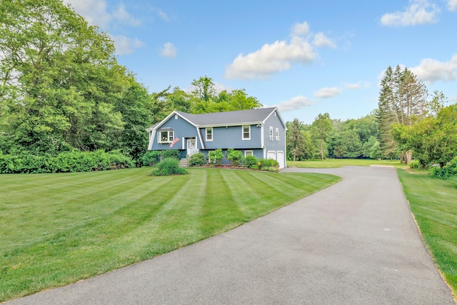 175 Cross Hill Rd, Monroe, CT 06468 - raised ranch with asphalt driveway, a garage, and a front lawn