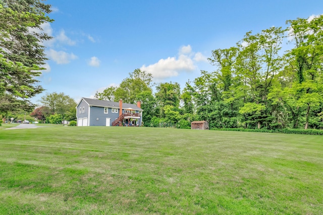 175 Cross Hill Rd, Monroe, CT 06468 - view of grassy yard featuring stairway, an attached garage, and a wooden deck