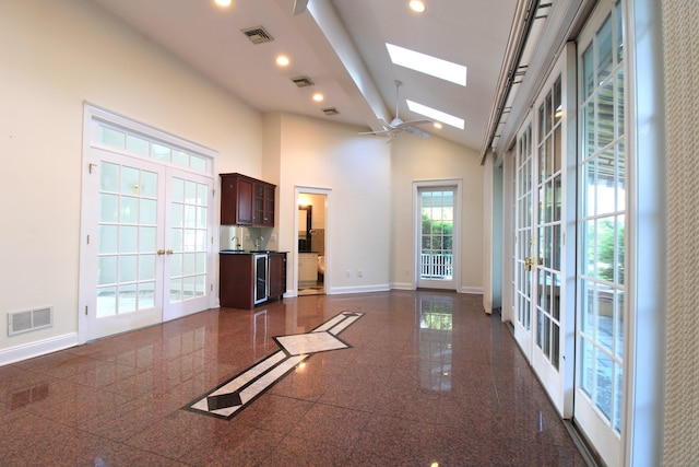 11 Pheasant Ridge Rd, Newtown, CT 06470 - unfurnished living room with french doors, a skylight, granite floors, vaulted ceiling, and recessed lighting